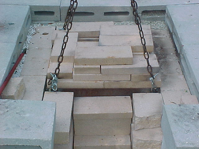 frame with bricks stacked in place on top of furnace